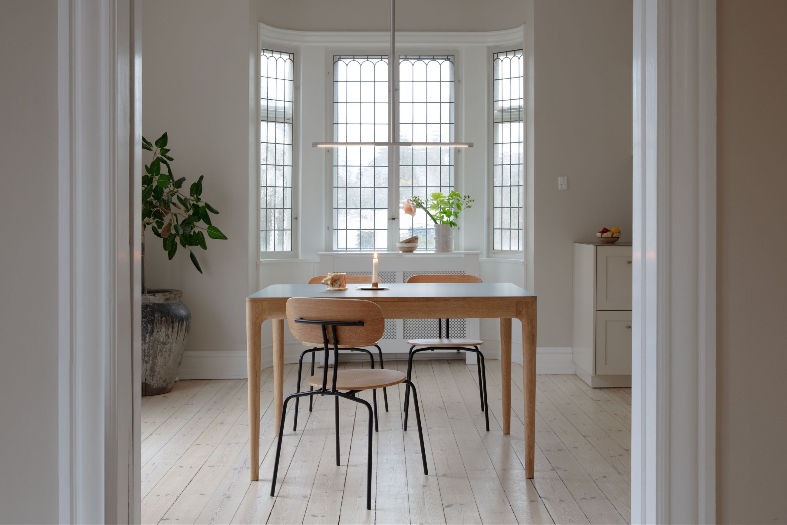 Dining room in soft daylight with sofa and table lamp