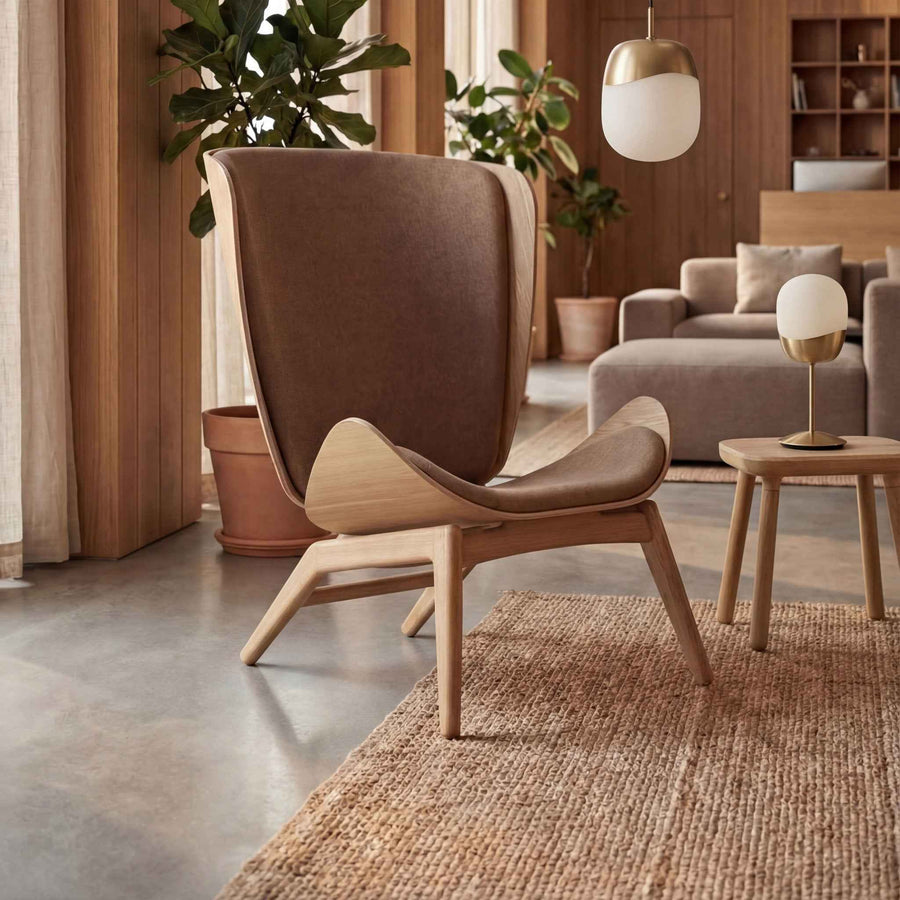 UMAGE_lifestyle_The Reader_oak_sugar brown_Paff_travertine_oak_Spring_pendant lampshade_medium_large_brass_Spring_table lamp_brass.jpeg